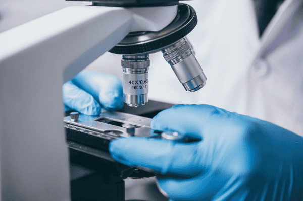 research-and-development-increase-in-collagen-cells (1) scientist analyzing eye and skin health solutions with microscope